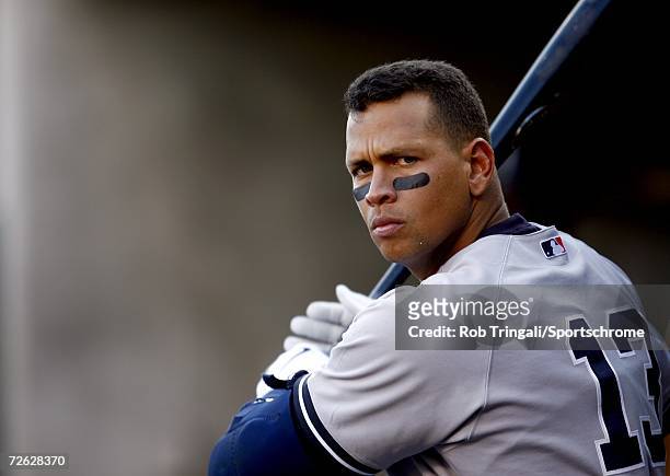 Alex Rodriguez of the New York Yankees warms up in the dugout in a game against the Detroit Tigers during Game Four of the 2006 American League...