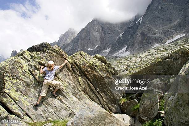 a young girl boulders on the granite rock near the aiguille du midi cable car (plan de l'aiguille). - aiguille de midi stock-fotos und bilder