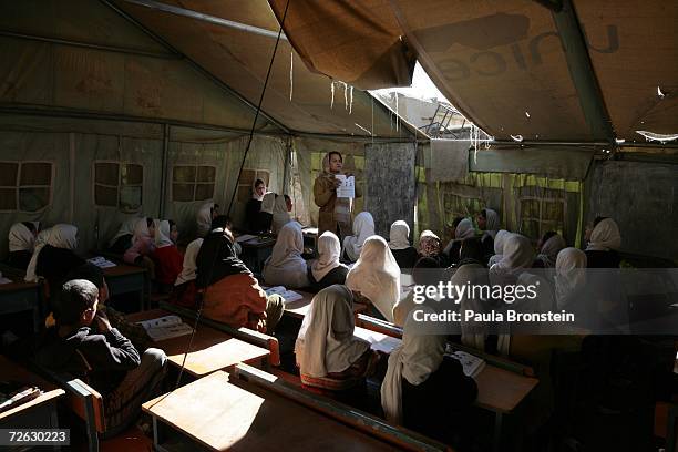 Afghan girls pack a tented classroom during english class at the Bibi Mahroo high school in Kabul, Afghanistan November 22, 2006. The overcrowded...