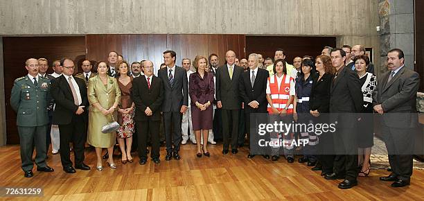 Santa Cruz de Tenerife, SPAIN: Spain's King Juan Carlos and Queen Sofia pose with rescue services during a visit in Santa Cruz de Tenerife 22...