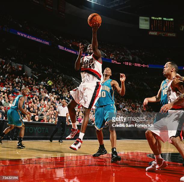 Zach Randolph of the Portland Trail Blazers goes for a layup past David West of the New Orleans/Oklahoma City Hornets during a game at The Rose...