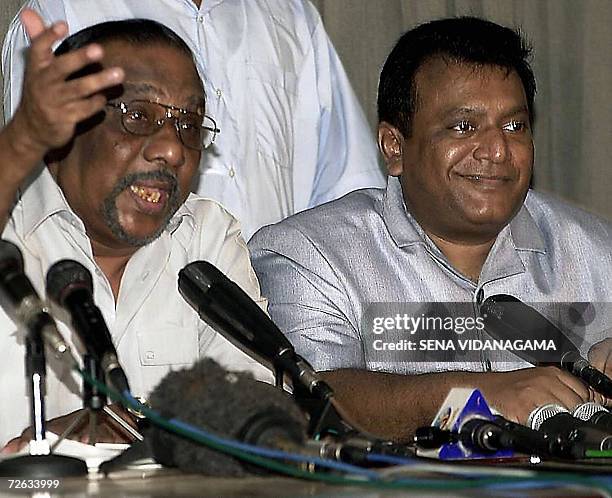 In this picture taken 10 April 2002, Sri Lankan Tamil Tiger guerrilla leader, Velupillai Prabhakaran smiles while his chief negotiator, Anton...