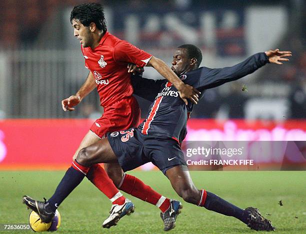 Paris Saint-Germain's midfielder Youssuf Mulumbu tackles Hapoel Tel Aviv's midfielder Messaye Degu during the UEFA Cup group G football match PSG vs....