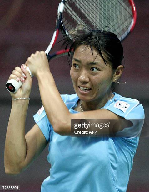 Japanese tennis player Tomoko Yonemura returns a stroke during her match against Chinese opponent Shuai Zhang in the womens singles for The Asian...