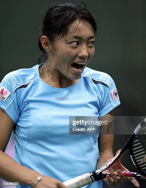 Japanese tennis player Tomoko Yonemura reacts after playing a stroke during her match against Chinese opponent Shuai Zhang in the womens singles for...