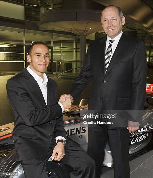 In this undated handout image released by McLaren F1 on November 24 21-year-old Lewis Hamilton poses with McLaren team principal Ron Dennis as it is...