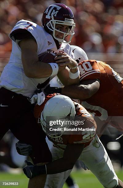 Quarterback Stephen McGee of the Texas A&M Aggies is tackled by Marcus Griffin and Robert Killebrew of the Texas Longhorns at Darrell K Royal-Texas...