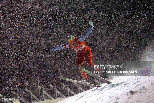 Last season's number one, Czech Republic's Jakub Janda tumbles in heavy snowfall during the qualifying round of the season's first World Ski Jumping...