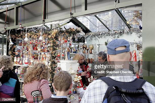People shop for Christmas ornaments in the holiday market the day after Thanksgiving in Bryant Park November 24, 2006 in New York City. Many shoppers...