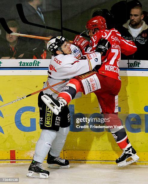 Andreas Morczinietz of Hanover fights for the puck with Alexander Engel of Duisburg during the DEL Bundesliga match between Hanover Scorpions and...