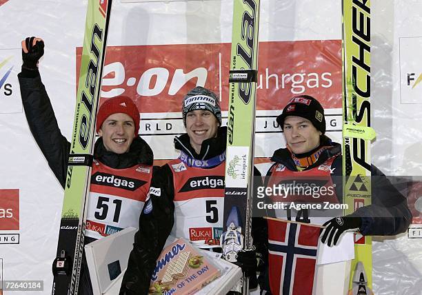 Second place Simon Amman of Switzerland, Winner Arttu Lappi of Finland and 3rd place Anders Jacobsen of Norway on the podium at the first Skijumping...