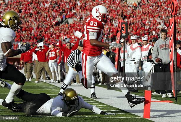 Wide receiver Terrence Nunn of the Nebraska Cornhuskers gets his toe in the endzone for a touchdown ahead of the diving reach of safety J.J....