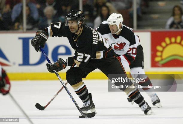 Scott Niedermayer of the Anaheim Ducks skates the puck through the netural zone against the New Jersey Devils in the third period during their game...