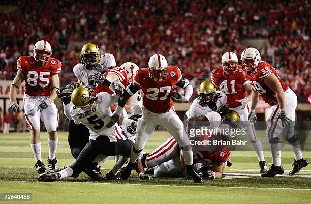 Kenny Wilson of the Nebraska Cornhuskers breaks through the defensive line past safety J.J. Billingsley of the Colorado Buffaloes for a touchdown in...