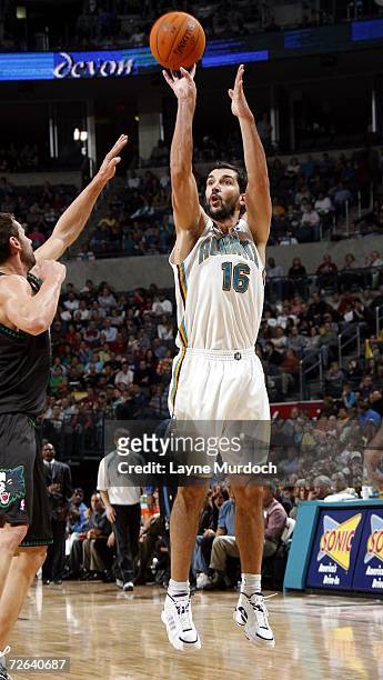 Peja Stojakovic of the New Orleans/Oklahoma City Hornets shoots the ball over Marko Jaric of the Minnesota Timberwolves during an NBA game on...