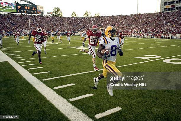 Trindon Holliday of the LSU Tigers returns a kick off for a touchdown against the Arkansas Razorbacks at War Memorial Stadium on November 24, 2006 in...