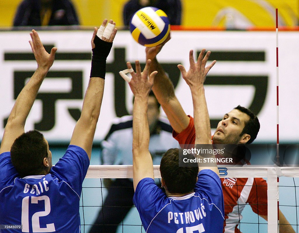 Victor Rivora Victor Rivera of Puerto Rico drops the ball over Andrija Geric and ...