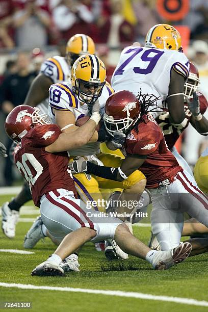 Jacob Hester of the LSU Tigers gets tackled by Chris Houston and Weston Dacus of the Arkansas Razorbacks at War Memorial Stadium on November 24, 2006...