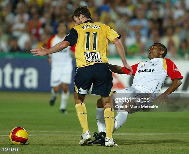 Romario of Adelaide is challenged by Damien Brown of the Mariners during the round fourteen Hyundai A-League match between the Central Coast Mariners...