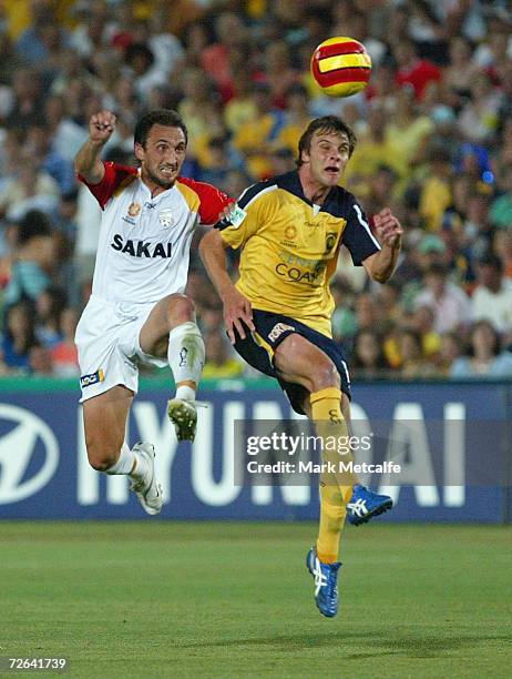 Michael Valkanis of Adelaide and Adam Kwasnik of the Mariners battle for the ball during the round fourteen Hyundai A-League match between the...