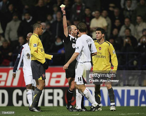 Kevin Davies of Bolton Wanderers receives a yellow card from referee Mike Dean during the Barclays Premiership match between Bolton Wanderers and...