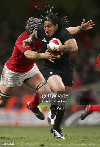 Ma'a Nonu of the All Blacks runs through the tackle of Alun Wyn Jones during the international rugby match between Wales and New Zealand at the...