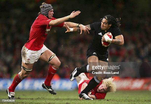 Ma'a Nonu of the All Blacks runs through the tackle of Alun Wyn Jones and Duncan Jones during the international rugby match between Wales and New...