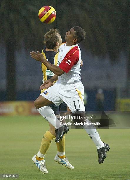 Romario of Adelaide and Stewart Petrie of the Mariners compete for the ball during the round fourteen Hyundai A-League match between the Central...