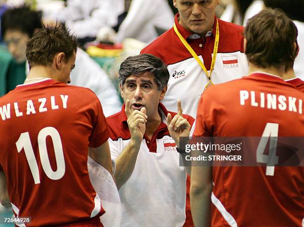 Poland's head coach Raul Lozano of Argentina gives directions to players Mariusz Wlazly and Daniel Plinski during their Pool E second round match...