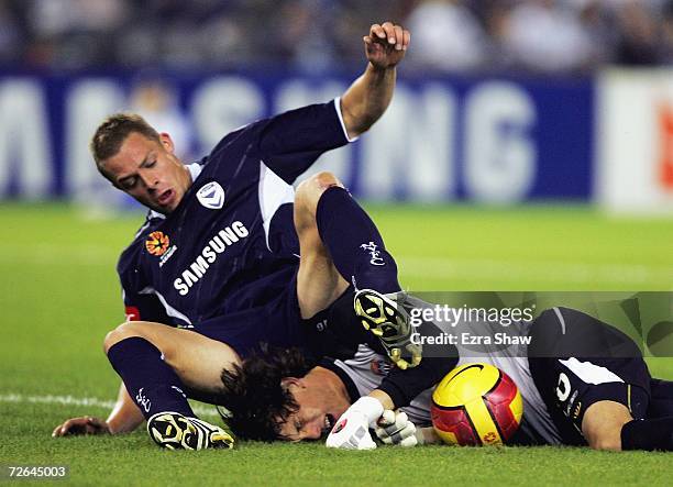 Daniel Allsopp of the Victory collides with Jets' goalkeeper Ben Kennedy during the round 14 Hyundai A-League match between Melbourne Victory and the...