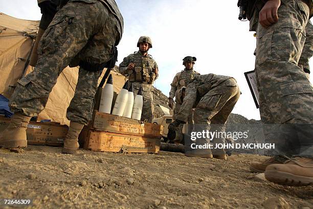 Soldiers from Headquarters and Headquarters Battery with 4th Battalion, 25th Field Artillery, 10th Mountain Division, prepare to fire their Howitzer...