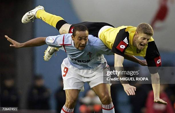 Real Zaragoza's defender Sergio Fernandez falls over Celta Vigo's Brazil's Fernando Nelo Baiano during their Spanish first League football match at...