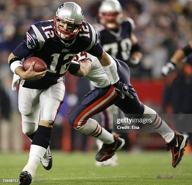 Tom Brady of the New England Patriots slips past Brian Urlacher of the Chicago Bears to get the first down on November 26, 2006 at Gillette Stadium...