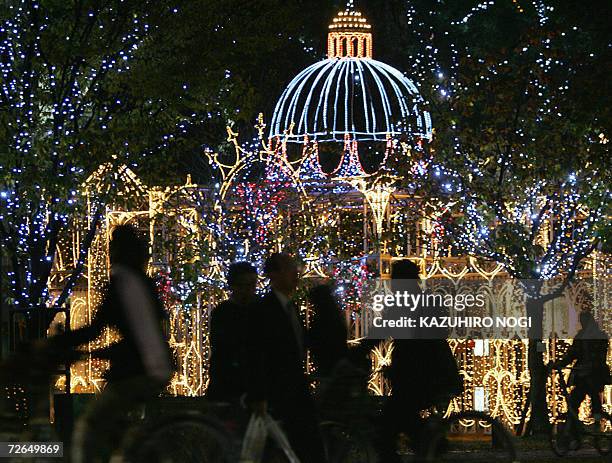 People walk in front of an illumination called 'peace castle' displayed along the peace street Hiroshima, 27 November 2006. Some 45 spots of the...