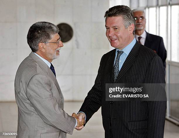 Brazil's Foreign Affairs Minister Celso Amorim shakes hands with visiting Belgian Foreign Minister, Karel De Gucht, in Brasilia, 21 November 2006....