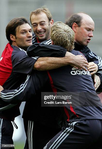 Assistant Roland Koch arms Alpay and Carrsten Cullmann during the 1.FC Cologne training session on November 27, 2006 in Cologne, Germany.