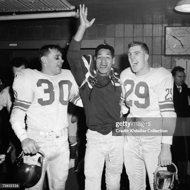 Linebacker Bill Svoboda, defensive back Emlen Tunnell and runnigback Alex Webster, of the New York Giants, celebrate in the clubhouse after the NFL...