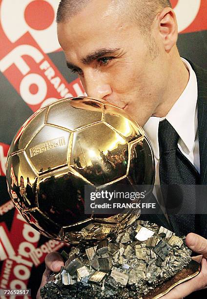 Italy's World Cup-winning captain Fabio Cannavaro kisses his trophy after being awarded the 2006 'Ballon d'Or' , for best football player of the...
