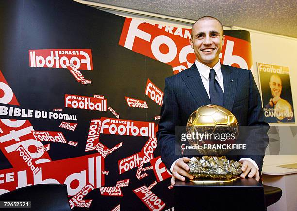 Italy's World Cup-winning captain Fabio Cannavaro poses next to his trophy after being awarded the 2006 'Ballon d'Or' , for best football player of...