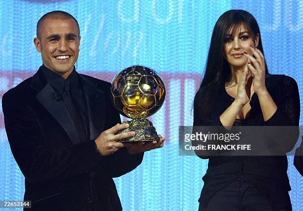 Italy's World Cup-winning captain Fabio Cannavaro is congratuled by actress Monica Belluci after being awarded the 2006 'Ballon d'Or' , for best...