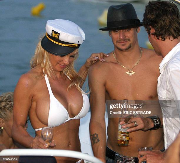 Photo dated 29 July 2006 shows Canadian actress Pamela Anderson sharing a drink with her husband US musician Kid Rock on the day of their wedding on...