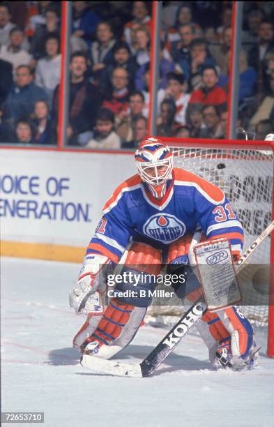 Canadian professional ice hockey player Grant Fuhr of the Edmonton Oilers in goal during a game against the Philadelphia Flyers, the Spectrum,...