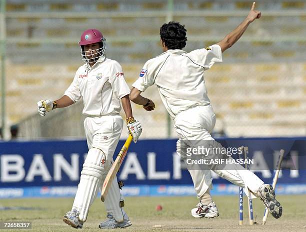Pakistani bowler Umar Gul celebrates the dismissal of West Indies batsman Ramnaresh Sarwan during the second day of the third and final Test match...