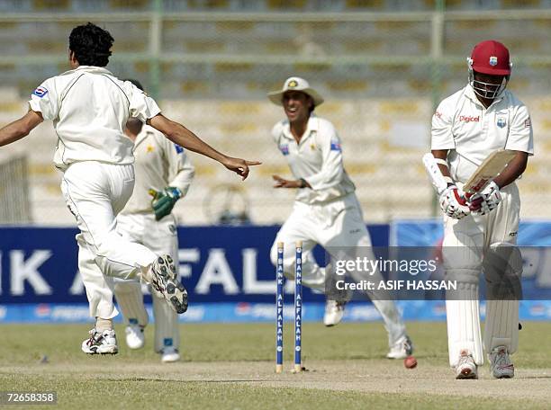 Pakistani bowler Umar Gul celebrates the wicket of West Indies captain Brian Lara during the second day of the third and final Test match between...