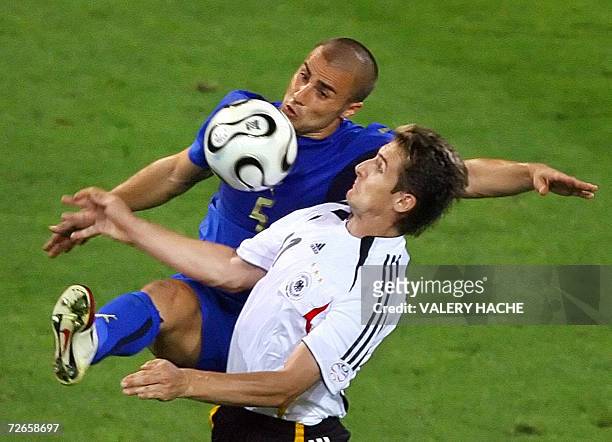 Italian defender Fabio Cannavaro fights for the ball with German forward Miroslav Klose during the World Cup 2006 semi final football game Germany...