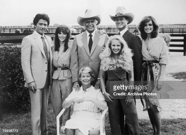 Group portrait of the Ewing family from the U.S. Television soap opera 'Dallas', circa 1980. Standing, left to right: Bobby , Pam , Jock , Lucy ,...