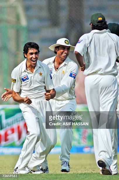 Pakistani bowler Umar Gul celebrates with his teammates Younis Khan and Danish Kaneria after taking the wicket of West Indies cricketer Ramnaresh...