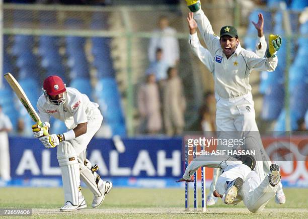 Pakistani wicketkeeper Kamran Akmal reacts after a drop by his teammate Imran Farhat off West Indies cricketer Daren Ganga during the second day of...