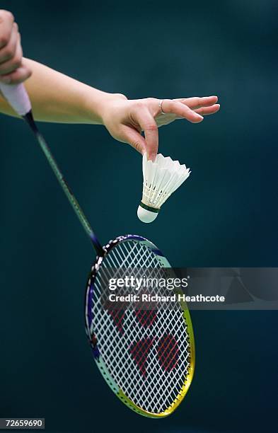 An athlete prepares to hit the shuttlecock while warming up on the Badminton courts prior to the start of the 15th Asian Games Doha 2006 at Aspire in...