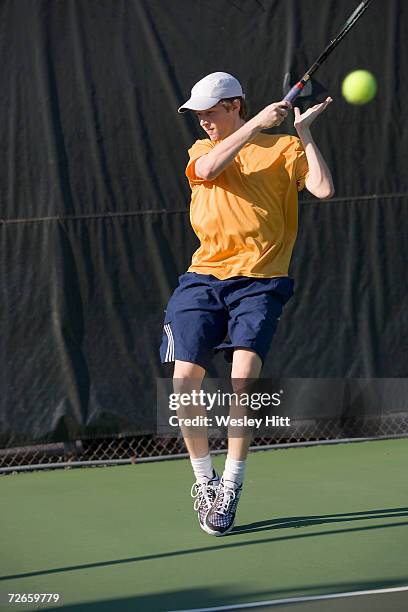 teenage boy (16-17) playing tennis - mission court grip stock pictures, royalty-free photos & images